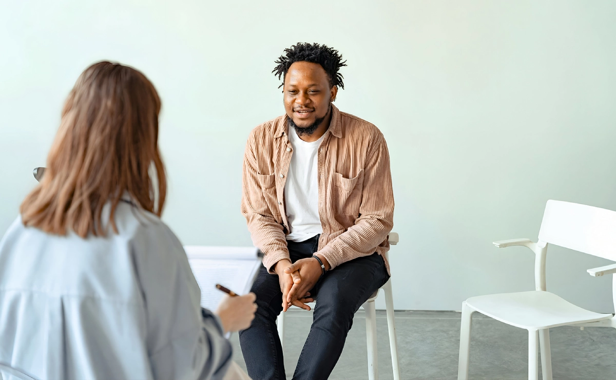 A man sitting in front of another person.