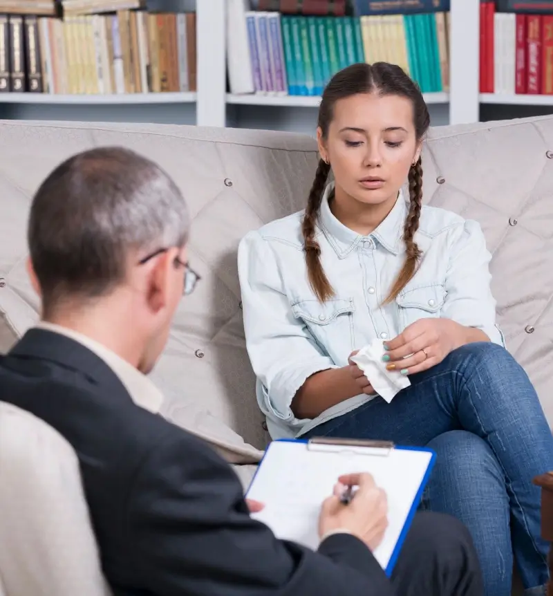 A woman sitting on the couch with a man.